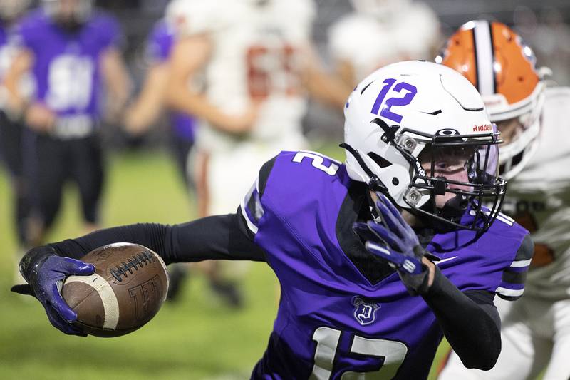 Dixon’s Gabe Rowley looks for yards after making a pass against Byron Friday, Oct. 18, 2024, at A.C. Bowers Field in Dixon.