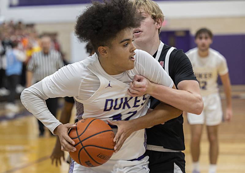 Dixon’s Darius Harrington works down low against Kewanee’s Brady Clark Tuesday, Nov. 28, 2023 in Dixon.