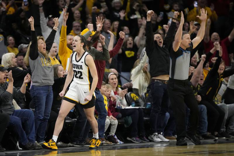 Iowa guard Caitlin Clark reacts after breaking the NCAA women's career scoring record during the first half against Michigan, Thursday, Feb. 15, 2024, in Iowa City, Iowa.