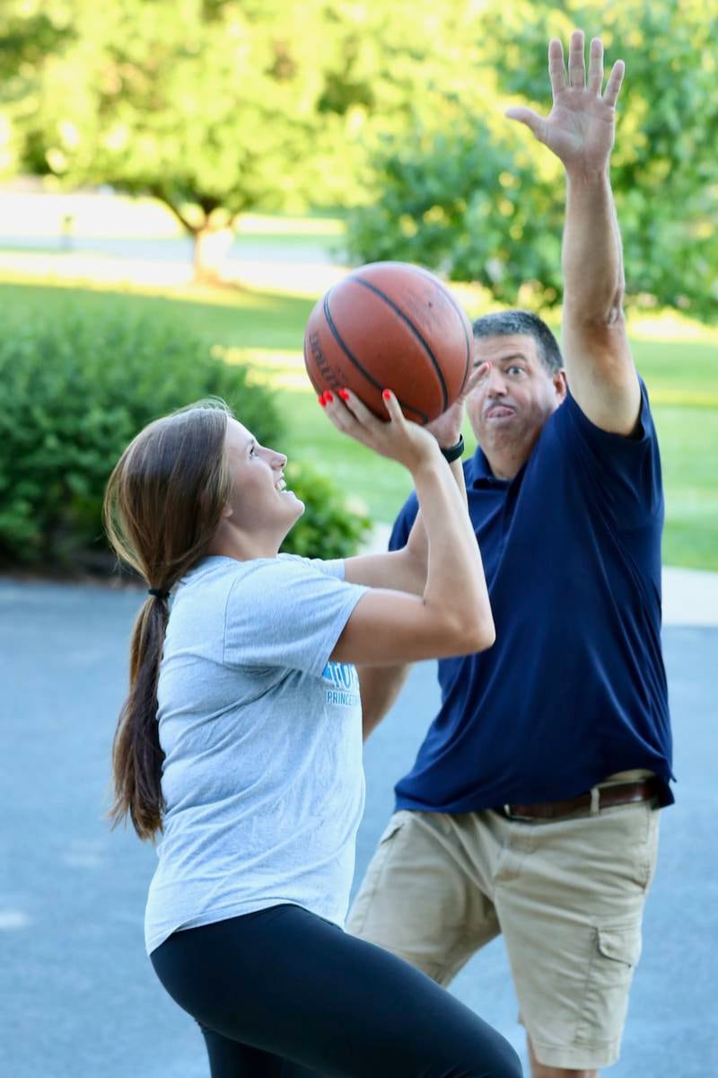 Mckenzie and Jason Hecht share a game of 1 on 1 on the family driveway hoop at Bryant Woods in Princeton. Mckenzie has found her dad to be a source of inspiration having overcome losing an eye to a fireworks accident in high school and continue to play sports.