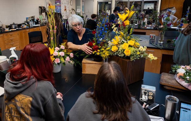 Kishwaukee College horticulture students learning Ronda Hess's floral arrangement techniques