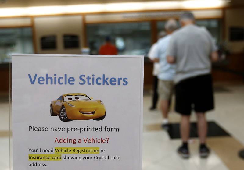 People line up Thursday, June 1, 2023, to purchase their Crystal Lake vehicle permit stickers at Crystal Lake City Hall. Crystal Lake is one of the few towns in McHenry County that require them.