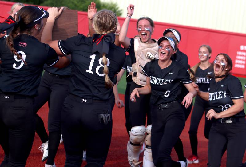 Huntley’s Red Raiders celebrate a win over Barrington in sectional final softball action at Barrington Friday.