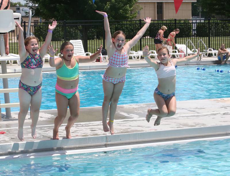 (From left) Claire Trager, Aubrey Oppenlander, Emerson Poutre and Kaisley Ocepek jump in simultaneously in the water at Riordan Swimming Pool on Monday, June 17, 2024 in Ottawa. Temperatures remain above 90's throughout this week.