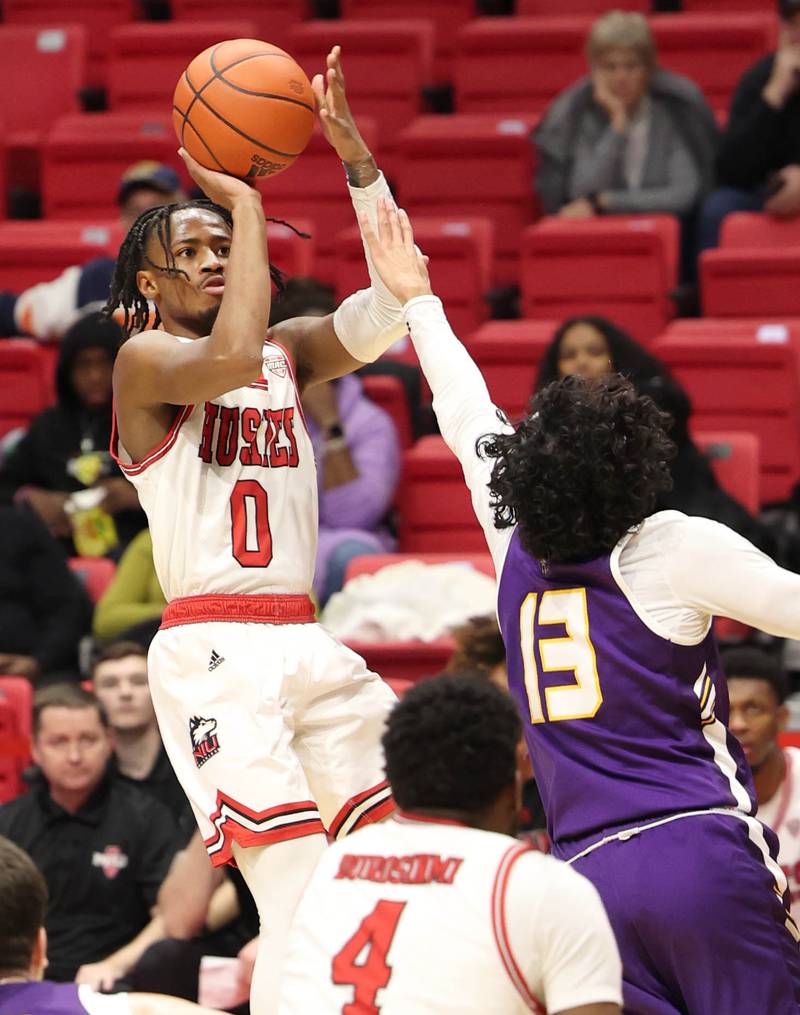 Northern Illinois Huskies guard Keshawn Williams shoots over Albany Great Danes guard Sarju Patel during their game Tuesday, Dec. 20, 2022, in the Convocation Center at NIU in DeKalb.