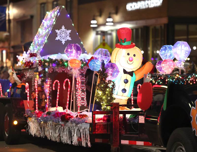 A colorful float makes its way through downtown in the parade Friday, Dec. 2, 2022, during Celebrate the Season hosted by the Genoa Area Chamber of Commerce.