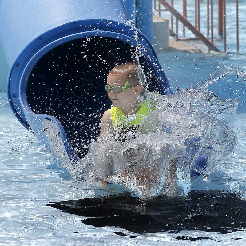 Aaron Appel, 6, makes a big splash as he goes down a slide while swimming on Friday, June 21, 2024, at Woodstock Water Works.