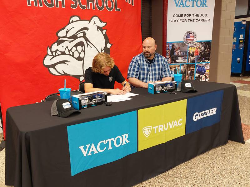 Graduating senior Daniel Koval signs his letter of intent Tuesday, May 14, 2024, to work at Vactor Manufacturing during a Signing Day event at Streator High School.