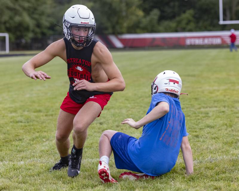 Riley Stevens of Streator High School breaks through the defensive player while practicing at Doug Dieken Stadium on August 12, 2024.