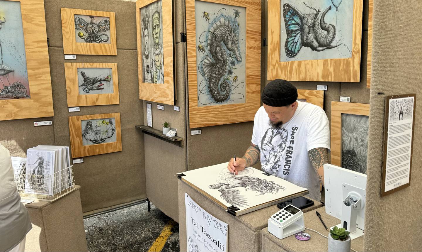 Missouri based artist Tai Taeoalii sketches with ballpoint pen during the annual Fine Art Show on May 25 and 26, 2024, in downtown St. Charles.