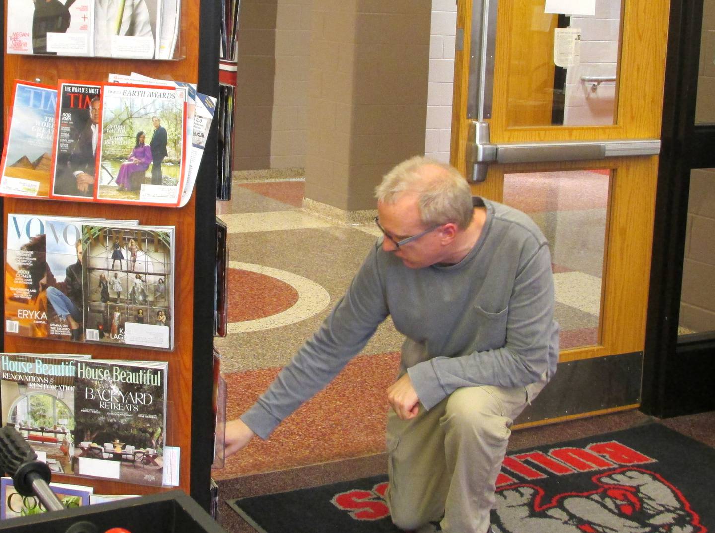 Streator High School English teacher and library media coordinator Chris Aubry searches for comic books to share with students who attended Hub Club.