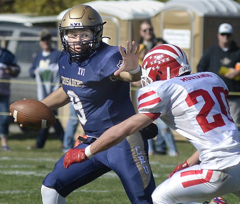 Marquette quarterback Alex Graham uses a stiff arm to get by Morrison’s Brady Anderson on a keeper in the first quarter during the Class 1A first round playoff game on Saturday, Oct. 29, 2022 at Gould Stadium in Ottawa.