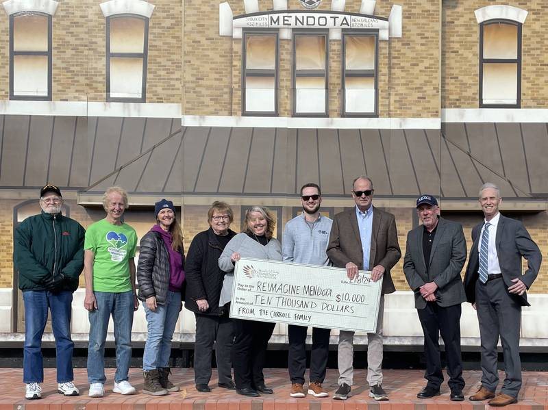 The Carroll family recently donated $10,000 to Reimagine Mendota through the Starved Rock Country Community Foundation. Pictured (from left) are Reimagine Mendota’s Bill Hein, Lee Stocking, Amy Brewer, Treasurer Janis Shirey and Annie Short; Evan and Matt Carroll; and Starved Rock Country Community Foundation board member Bill Hunt and CEO Fran Brolley.