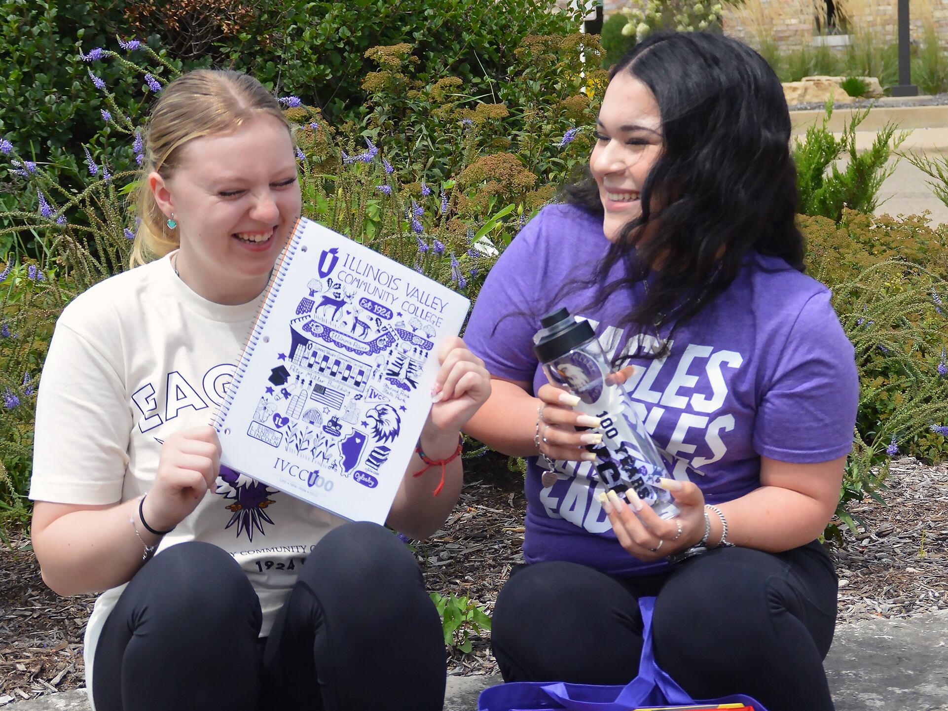 Delanie Young of Serena and Marlene Cadena of Wenona give just a tantalizing hint of some of the Illinois Valley Community College gear to be given away during Fall Preview. They’re excited for their classes to begin next week, too, but they’re also looking forward to welcoming and helping students in the Counseling and Admissions departments where they work.