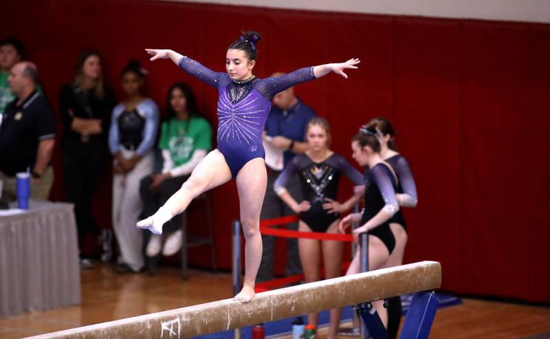 Downers Grove South’s Genevieve Herion competes on the balance beam during the IHSA Girls State Gymnastics Meet at Palatine High School on Friday, Feb. 16, 2024.