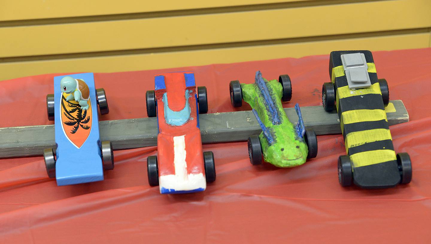 Some of the entries await their turn to race Saturday during the annual Scouting Pinewood Derby at the Peru Mall.