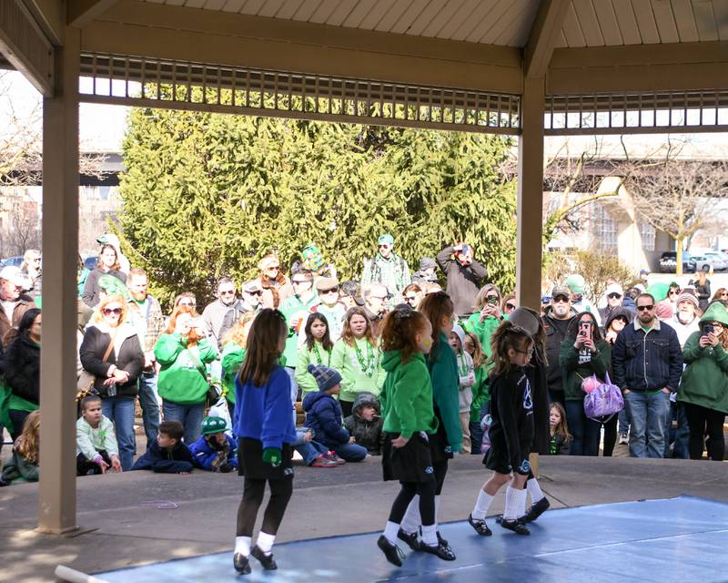 Community members watch dancers from Bailey Murray academy of Irish dancing during the St. Patrick’s festivities on Saturday March 9, 2024, in downtown Lemont.