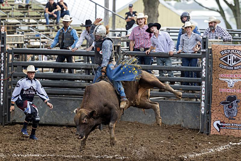 Jake Maher hangs on to “Mushhead” in the Rice Bull Riding and Barrel Racing event Thursday, August 11, 2023 at the Carroll County fair.