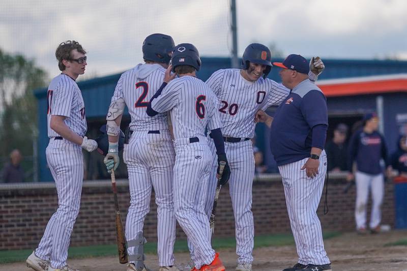 Oswego’s Dylan King (20) is greeted at home after hitting a three run homer against Yorkville during a baseball game at Oswego High School on Monday, April 29, 2024.