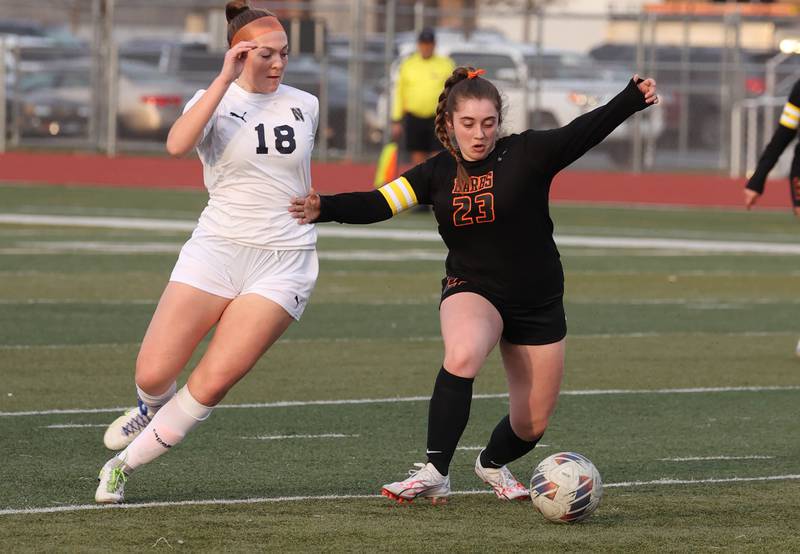 DeKalb’s Addison Elshoff tries to hold off Belvidere North's Cortlyn Hefty during their game Tuesday, March 12, 2024, at DeKalb High School.