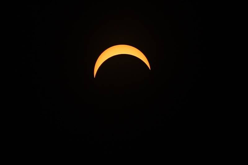 The moon passes in front of the sun at the Joliet Junior College solar eclipse viewing event on Monday, April 8, 2024 in Joliet.