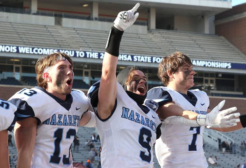 Nazareth players celebrate their IHSA Class 5A state championship win over Peoria Saturday, Nov. 26, 2022, in Memorial Stadium at the University of Illinois in Champaign.