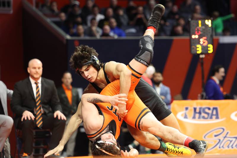 Fremd’s Evan Gosz rolls St. Charles East’s Jayden Colon in the 144-pound Class 3A state championship match on Saturday, Feb. 17th, 2024 in Champaign.