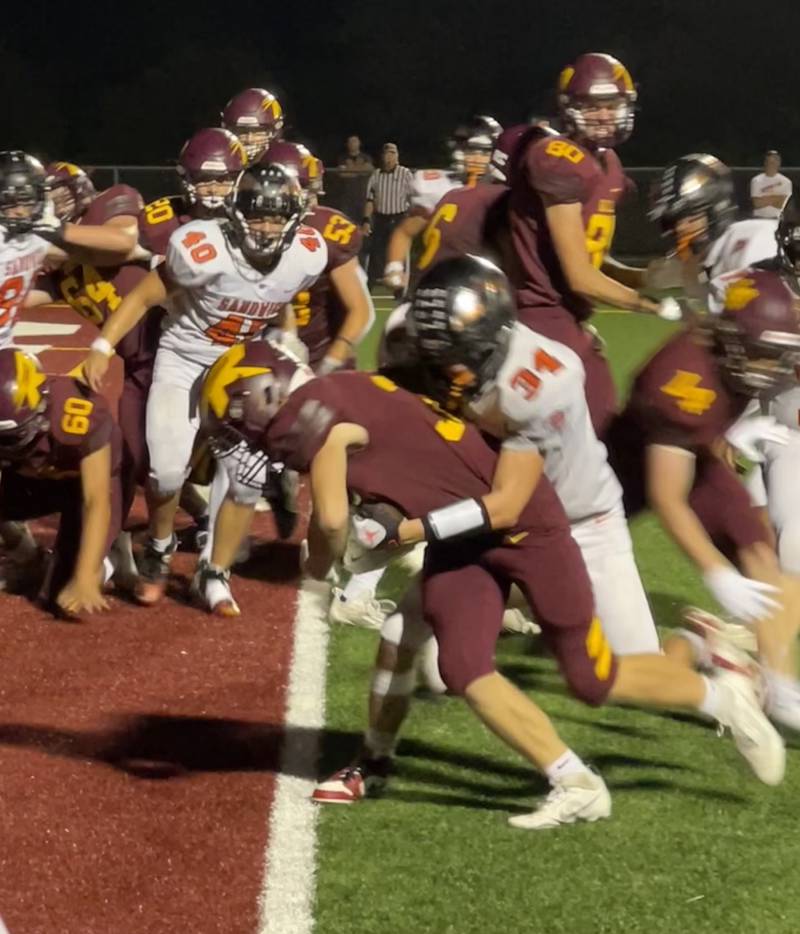 Richmond-Burton’s Isaac Jones battles through the tackle attempt of Sandwich’s Brodie Case and scores a touchdown during the Rockets’ 49-7 win over the Indians Friday.