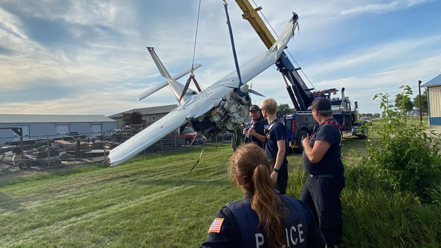 A Cessna 177 four-seater plane crashed in a Cortland corn field off West Lincoln Highway in DeKalb County a mile from its destination at DeKalb Taylor Municipal Airport Thursday, July 27, 2023. First responders look on as the plane was towed from the field by Lovetts Towing. Two men were injured in the crash and hospitalized, authorities said.