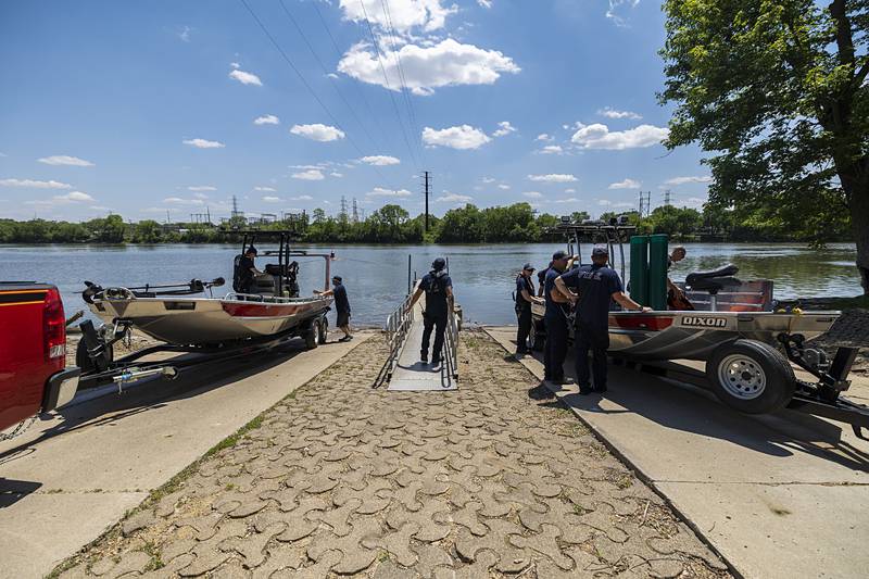 Dixon City and Rural firefighters launch boats at the Page Park ramp Thursday, May 23, 2024 to place buoys along the Rock River.