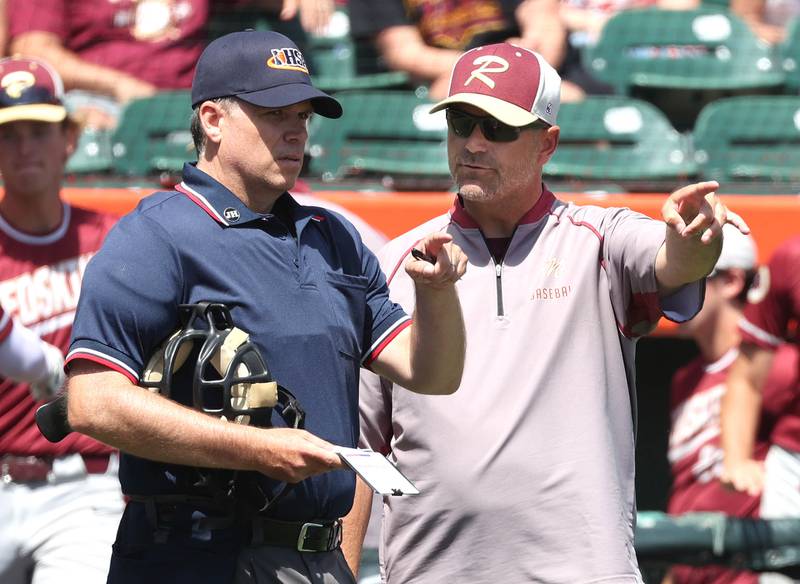 Morris head coach Todd Kein talks to an umpire during their Class 3A state semifinal game against Crystal Lake Central Friday, June 7, 2024, at Duly Health and Care Field in Joliet.