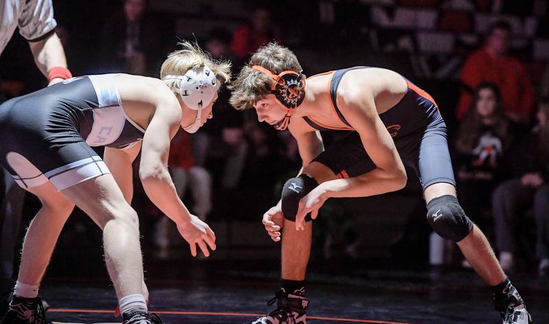Marian Central's Brayden Tuennisen and St. Charles East's Gavin Woodmancy wrestle at 126 pounds during a match in St. Charles on Wednesday, December 20, 2023.