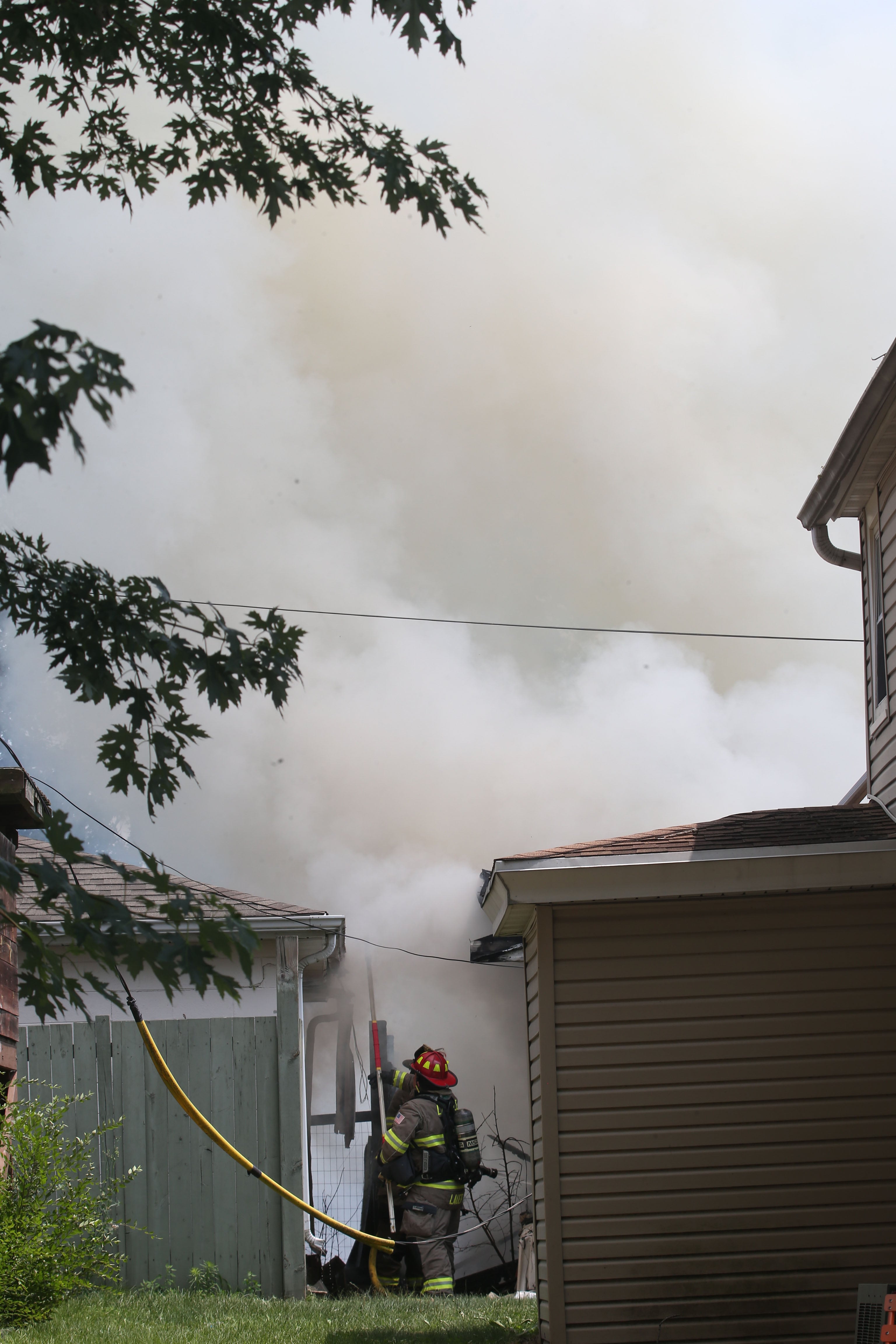 La Salle firefighter Nick Lauer works the scene of a garage fire in the 800 block of Lafayette Street on Monday, July 22, 2024. The fire began just before 1p.m. La Salle Fire and EMS along with Peru Fire department responded to the call while La Salle Police directed traffic.