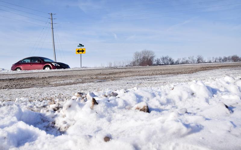 Traffic drives along Highway 14 between Newton and Monroe while surrounded by snow. Crews working to plow and haul snow prioritized major highways following recent snowstorms before addressing secondary roads, which enraged a number of residents who were trapped by high snowdrifts for several days.