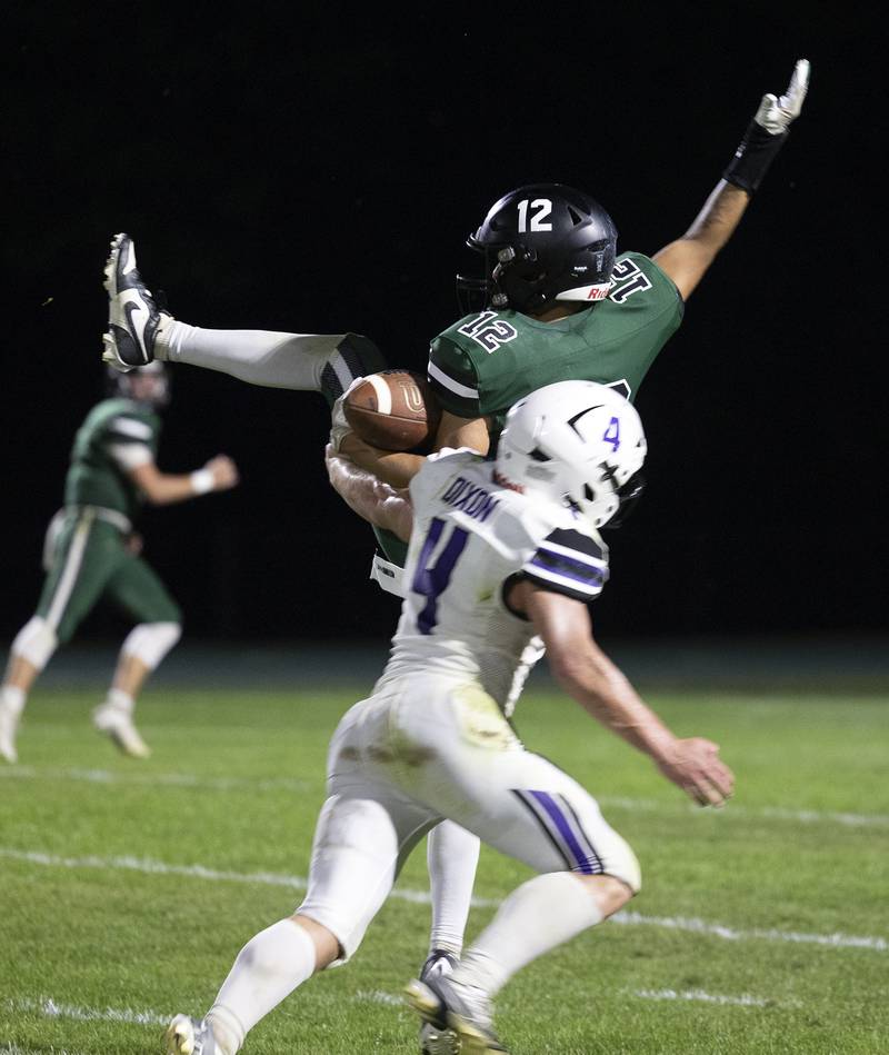 Rock Falls’ Austin Casteneda is hit by Dixon’s Landon Knigge Friday, Sept. 13, 2024, at Hinders Field in Rock Falls.