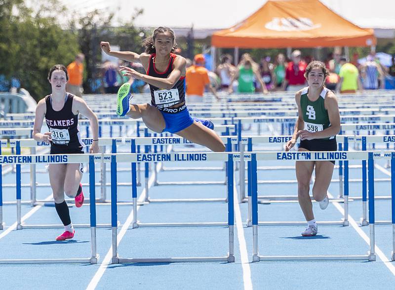 Newark’s Kiara Wesseh clears the last hurdle as Fulton’s Emery Wherry (left) and St. Bede’s Lily Bosnich chase her down in the 1A 100 Hurdles Saturday, May 18, 2024 at the IHSA girls state track meet in Charleston.