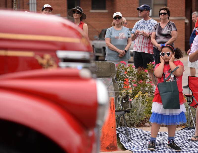 Noel Aragones of Downers Grove reacts to the loud sounds of the firetrucks during the Downers Grove Fourth of July Parade on Thursday, July 4, 2024.