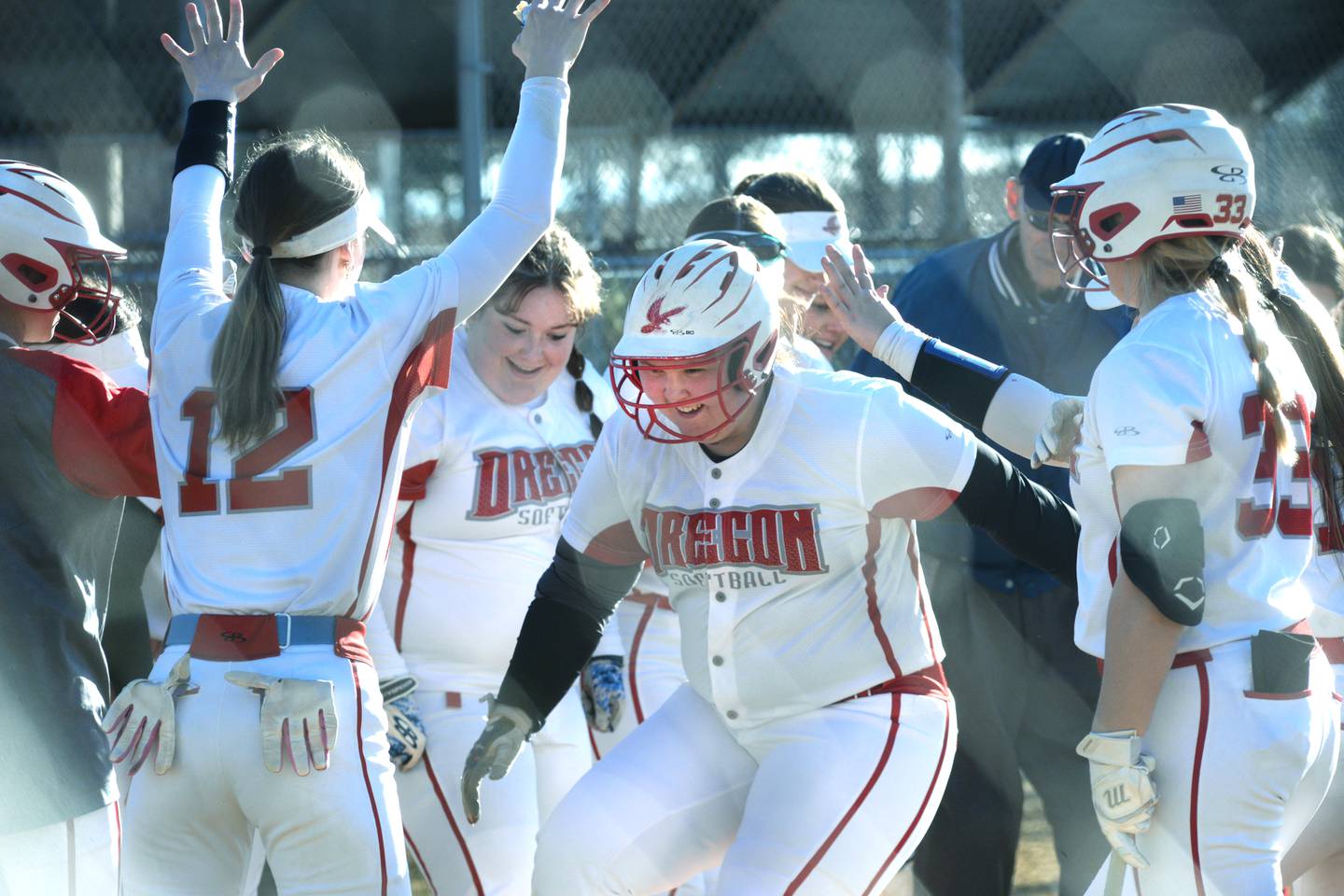 Oregon's Olivia Paul is greeted by her teammates at home plate after hitting a home run against Dixon on Friday, April 5, 2024 at Oregon Park West