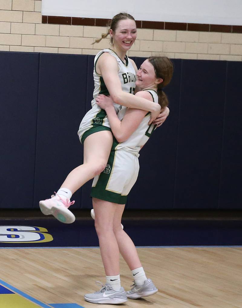 St. Bede's Ashton Ehm hugs teamate Lili McClain after defeating Amboy in the Class 1A Regional final on Friday, Feb. 16, 2024 at Marquette High School.