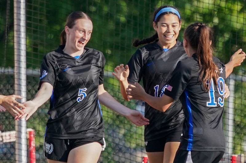 St. Charles North's Rian Spaulding (5) smiles after assisting on a goal by Juliana Park (18) against Batavia during a Class 3A Batavia Regional final soccer match at Batavia High School in Batavia on Friday, May 17, 2024.