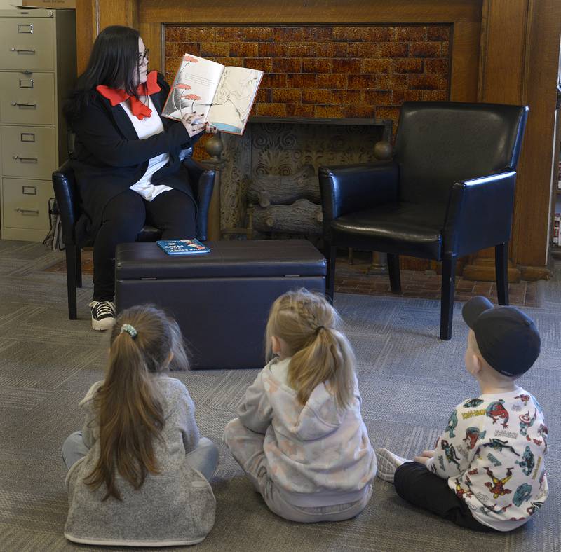 Kids and Teens Program Director Maddy Basina reads a book from the Dr. Seuss collection Saturday, March 2, 2024, at the Streator Public Library. A Seussical Celebration was held to commemorate the birthday of Dr Seuss.