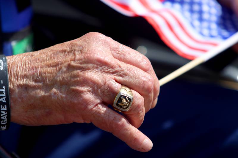 Army veteran Ben Jankowski of Woodstock holds a flag as McHenry Community High School hosted a celebration Sunday for veterans returning from an Honor Flight trip to Washington D.C. The Honor Flight trip was coordinated by the Veterans Network Committee of Northern Illinois.