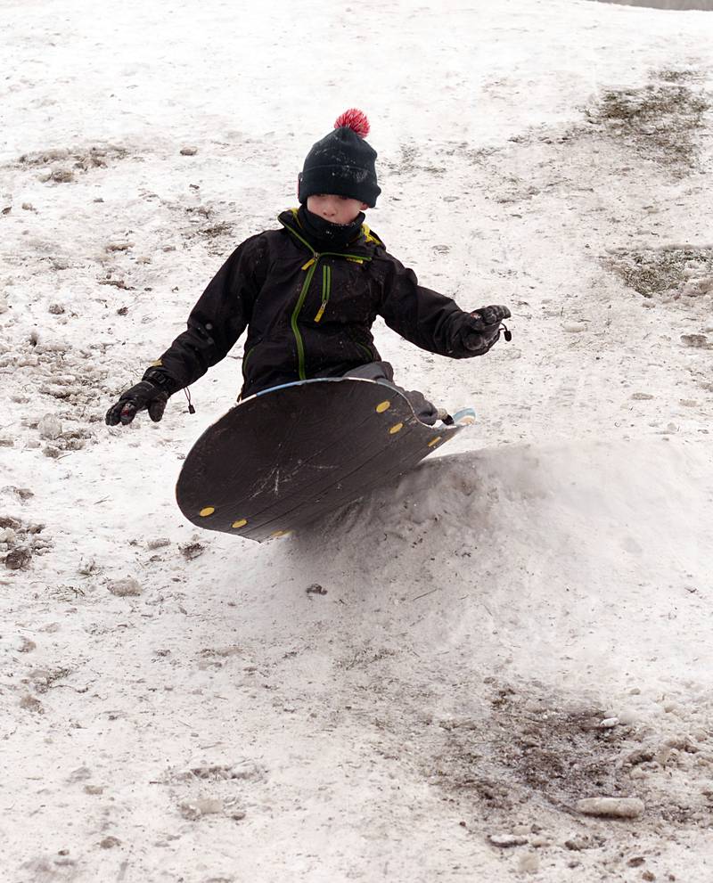 Children including Michael Parrino tough out the cold temperatures while sledding at Memorial Park in Lagrange Park Saturday, Jan 13, 2024.