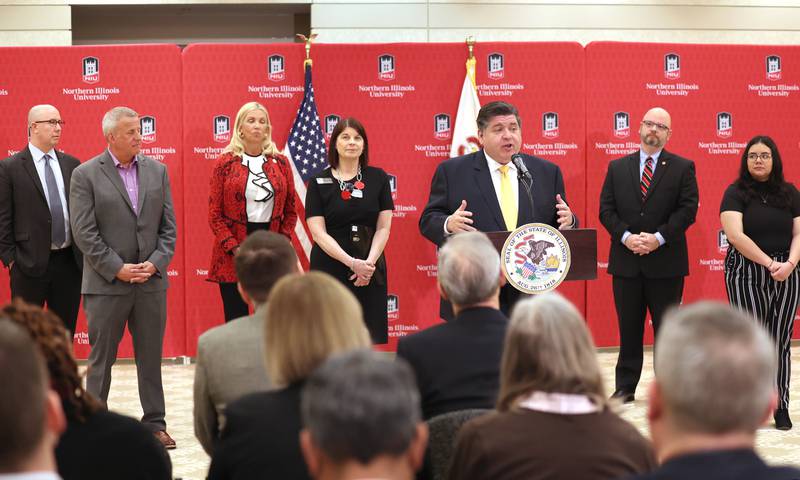 Gov. JB Pritzker, flanked by other state and local officials, speaks during a news conference Tuesday, April, 4, 2023, in the Barsema Alumni and Visitors Center at Northern Illinois University in DeKalb. Pritzker along with a group of llinois lawmakers, DeKalb city officials and representatives from NIU were on hand to promote the importance of funding higher education in Illinois.