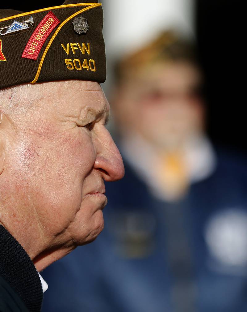 John Widmayer, of the Woodstock Veterans of Foreign Wars Post 5040 Honor Guard, listens as the names of McHenry County veterans who died in the Vietnam War are read during the “Voices from Vietnam,” program on Friday, March 29, 2024, at the McHenry County Government Administration Building in Woodstock. The program was the first time that McHenry County honored Vietnam veterans on Vietnam War Veterans Day. The day, that was created by federal law enacted in 2017, honors the more than 2.7 million American men and women who served in Vietnam.