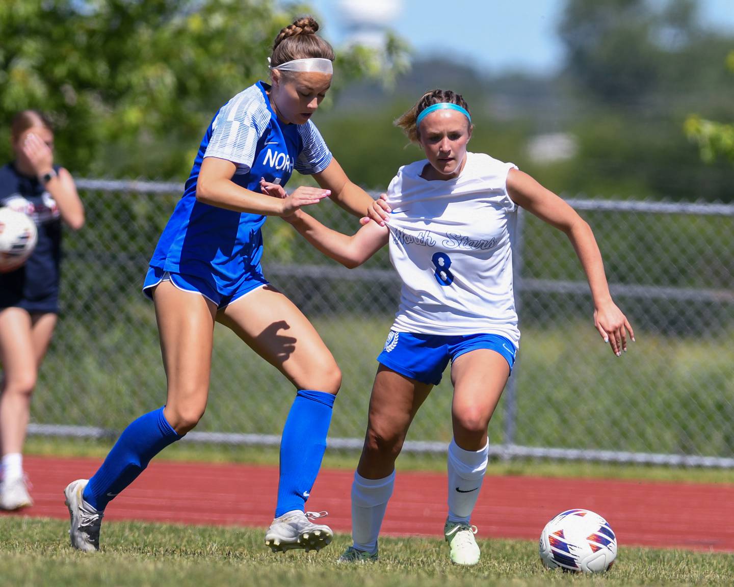 Wheaton North's Jane Rogers (8) and St. Charles North's Courtney Suhr (7) battle for the ball during the sectional title game on Saturday May 25, 2024.
