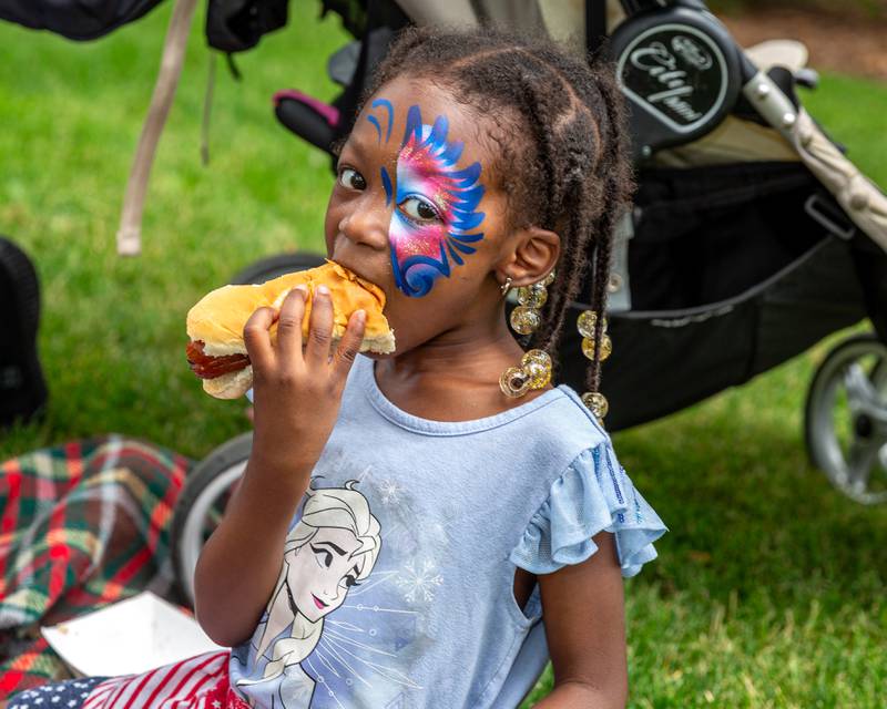 Celeste Dumfeh enjoys a hotdog at the Hinsdale 4th of July Family Celebration.  July 4th, 2024.