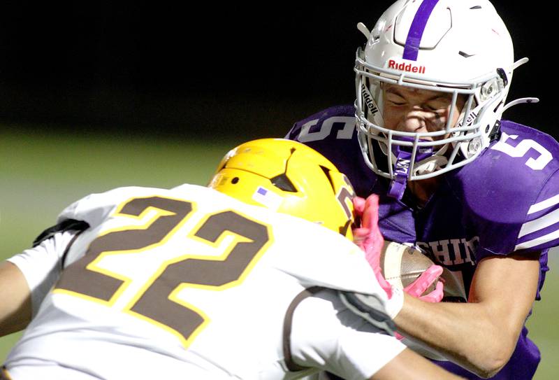 Hampshire’s Christian Dupuis, right, is hit by Jacobs’  Luke Gormsen in varsity football on Friday, Sept. 6, 2024, at Hampshire School in Hampshire.