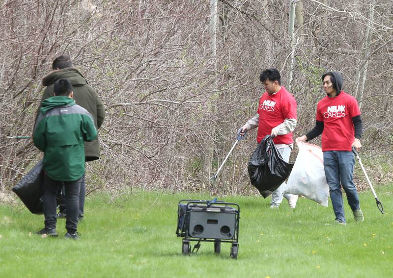 Northern Illinois University students with NIU Cares pick up garbage Friday, April 29, 2022, on campus near the West Lagoon. NIU Cares, with the help of the Trash Squirrels, was hosting a community cleanup event, going to several locations in DeKalb to pick up litter.