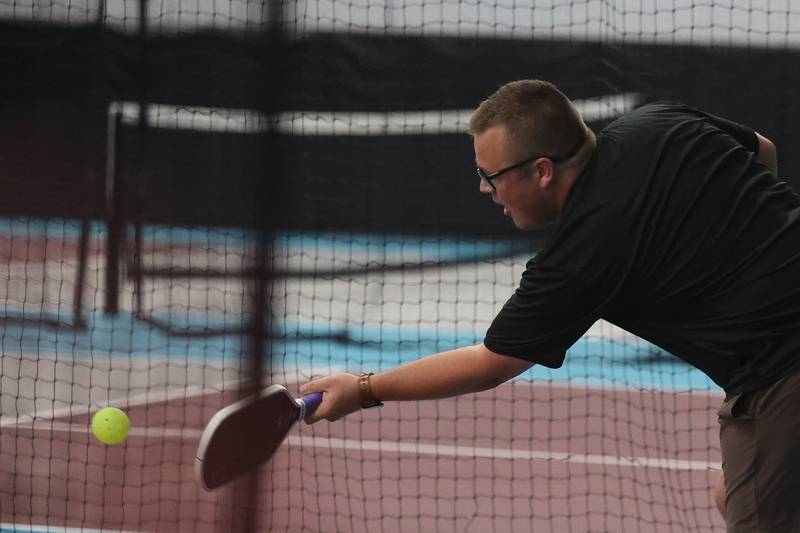 Mark Colantone returns the ball the ball in a pickleball league match at GameChangers on Tuesday, May 28, 2024 in Shorewood.